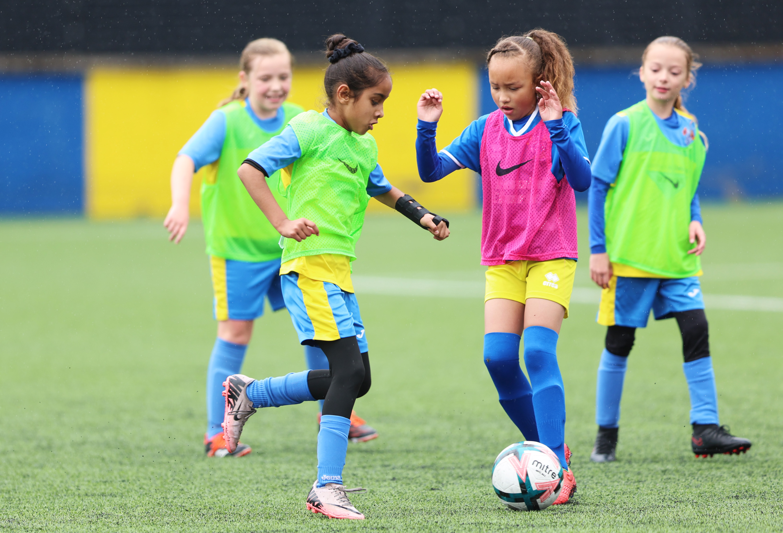 Girls taking part in a youth football training session